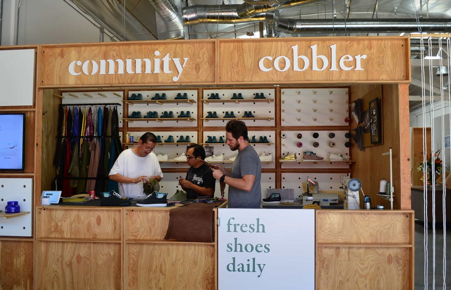 people working in a comunity brand selling shoes photo