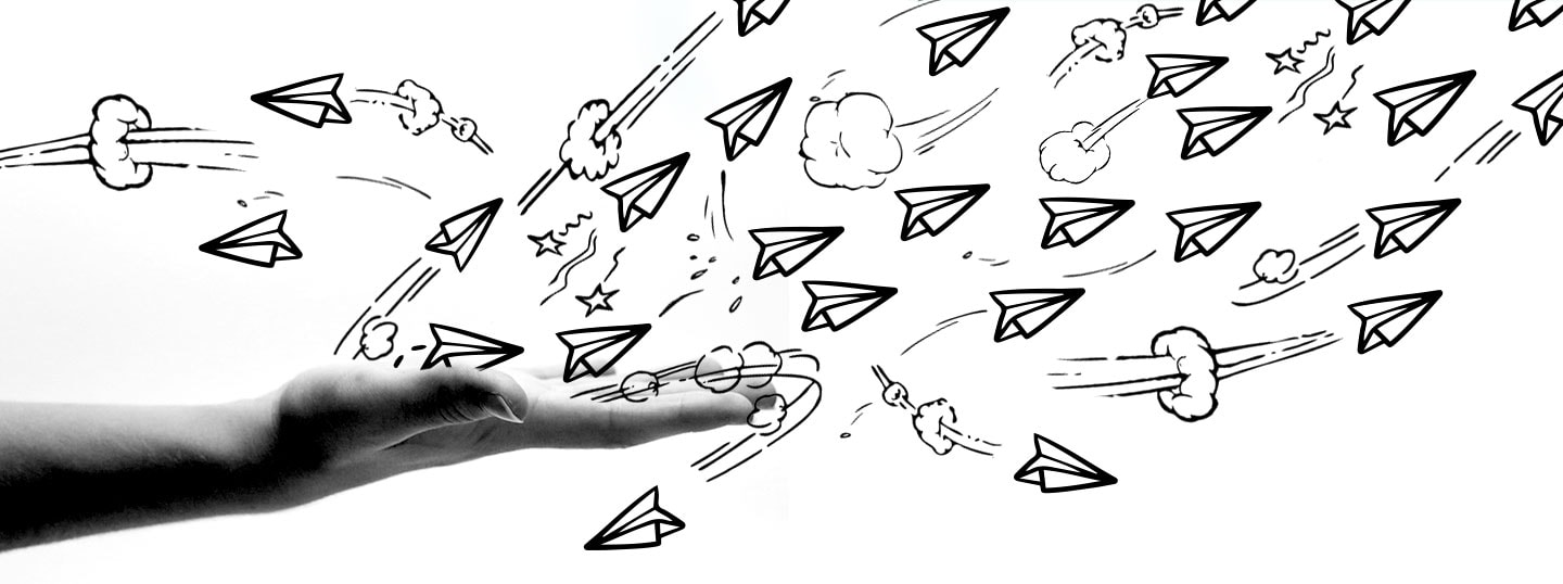 Black and white graphic design of real hand and cartoon paper planes