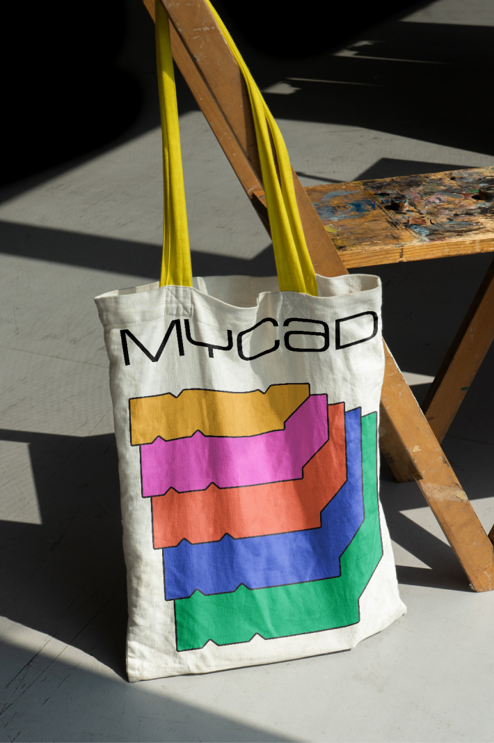 MYCAD branded cotton shopping bag hanged on an industrial chair