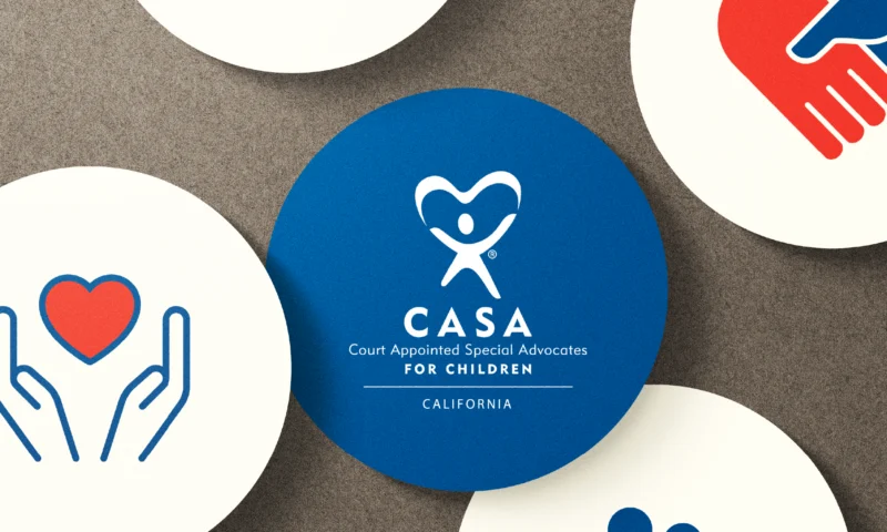 CASA logo on a blue circular badge surrounded by icons of hands, heart, and handshake, representing care, advocacy, and community support.